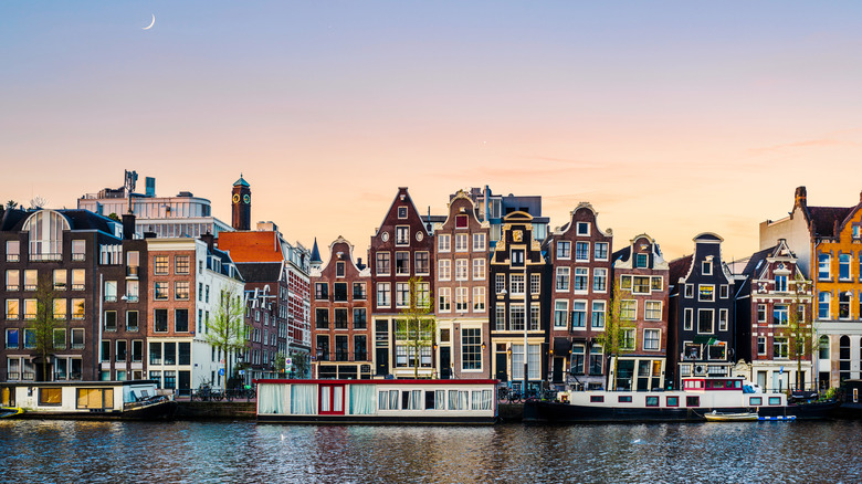 Buildings on the canal in Amsterdam at sunset