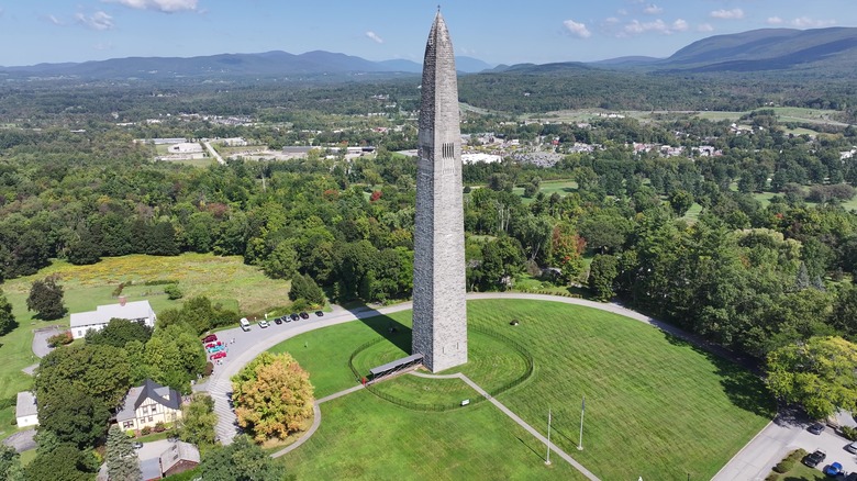 Bennington Battle Monument in field with mountains in distance