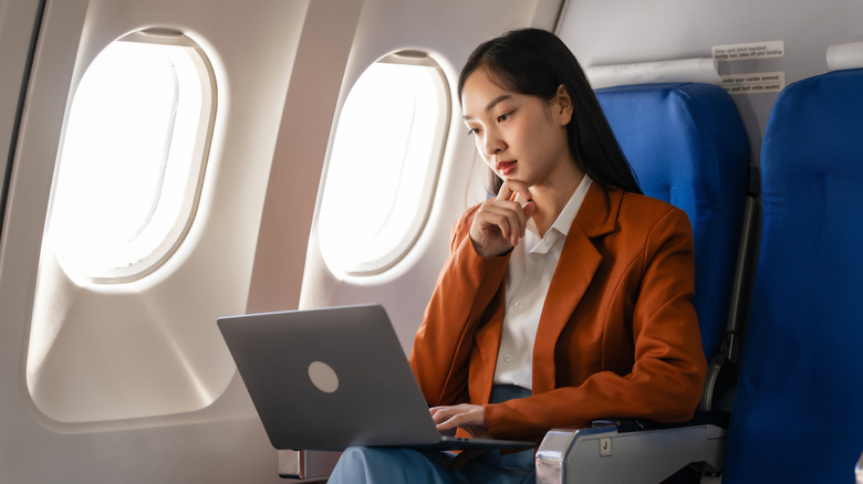 Person using WiFi on a plane