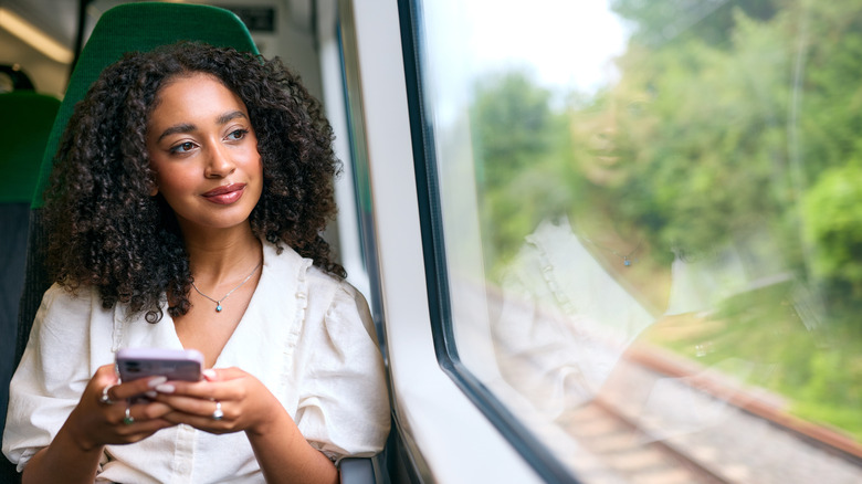 Someone looking out the window of a train