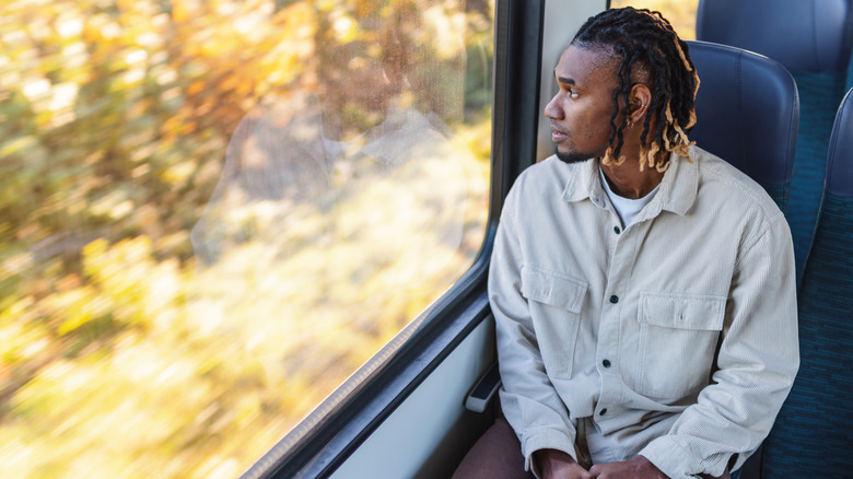 Man relaxing on a train's quiet car