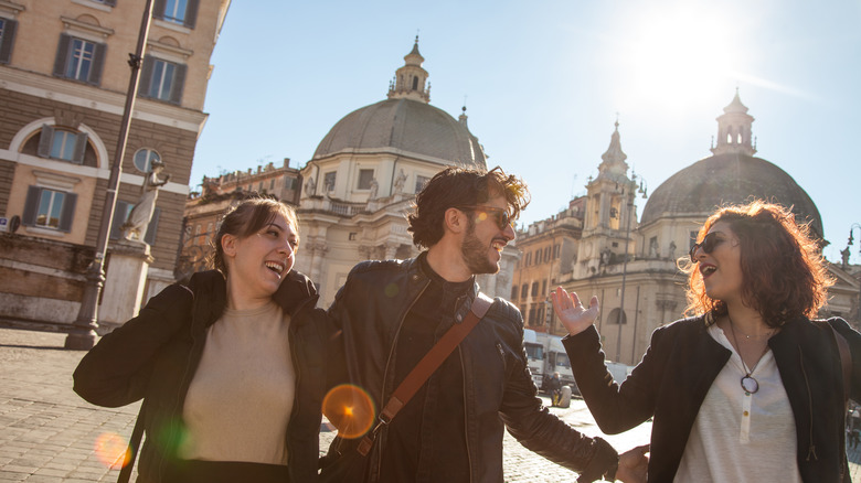 Three smiling friends on European street