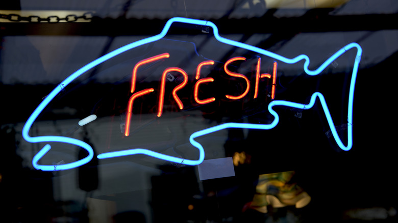 Neon 'Fresh Fish' sign in store window