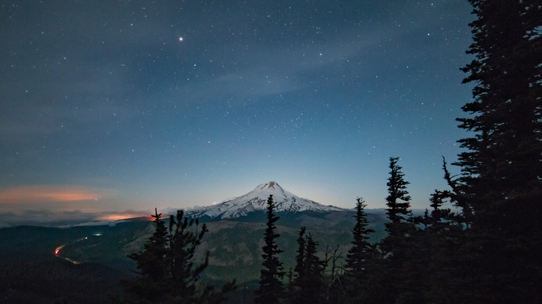 Snowcapped mountain at night with stars above