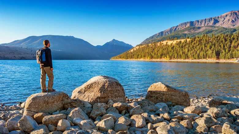 hiker staring across Wallowa Lake and Mountains in Joseph, Oregon