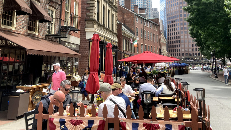 People eating on the outside terrace of the Union Oyster House in Boston, Massachusetts