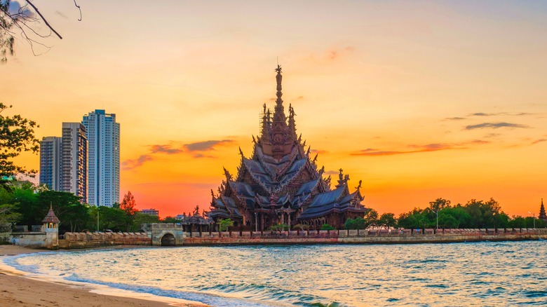 Pattaya beach at sunset with the wooden temple of Ministry of Truth