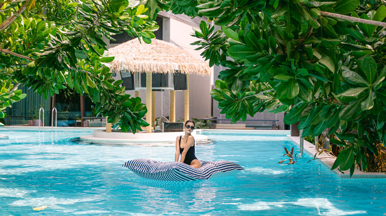 Woman floating in pool at La Miniera Pool Villas Pattaya