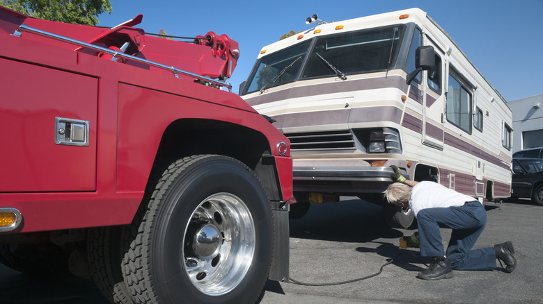 tow truck driver preparing RV