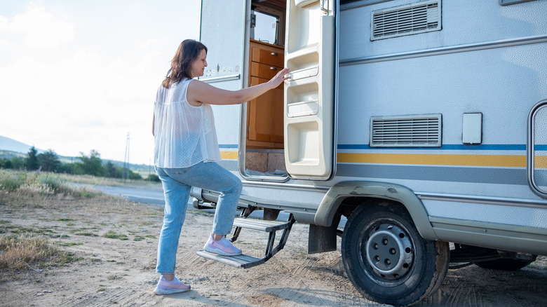 person using retracting RV steps