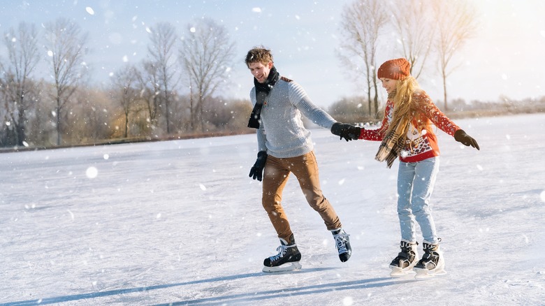 couple ice skating holding hands