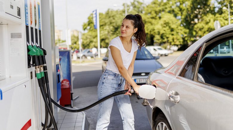 Woman refueling a car