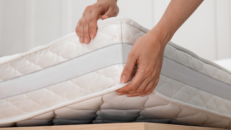 person lifting mattress