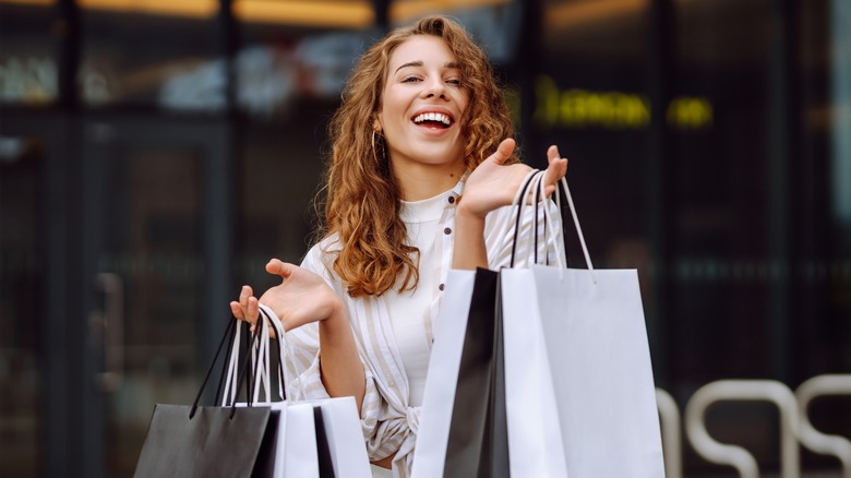 woman holding paper shopping bags