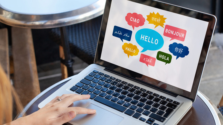 Person looking at laptop with hello written in different languages