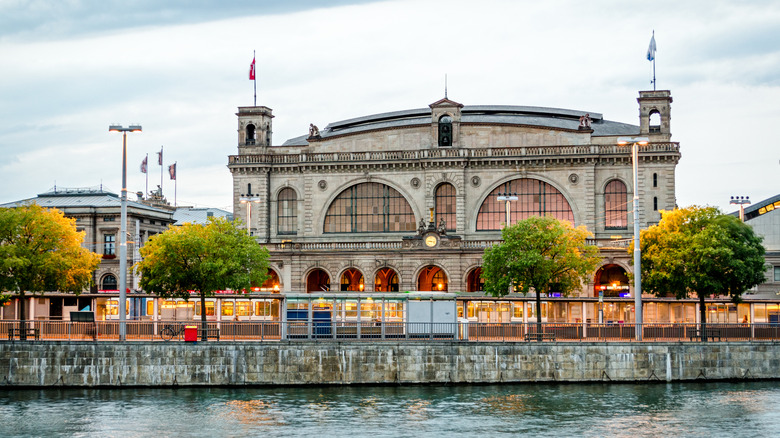 Facade of Zurich central train station at river bank