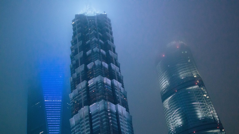 Shanghai skyscrapers in a dense fog at night