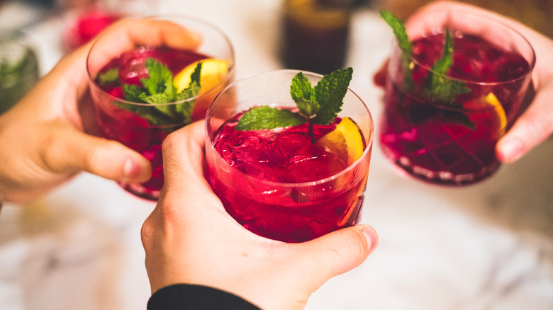 People toasting with glasses of sangria