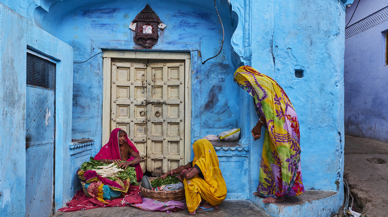 Three people in front of a door