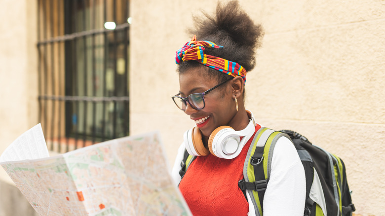 Woman looking at map smiling