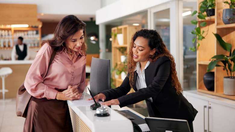 Woman getting advice from a hotel receptionist