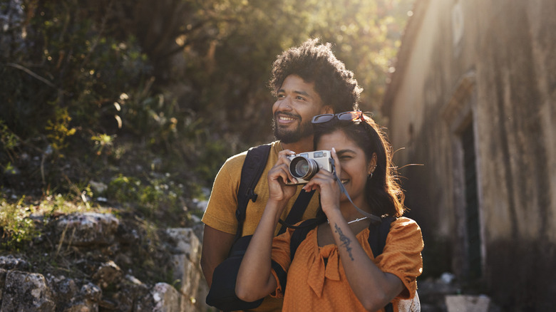 Couple sightseeing and taking photos on vacation