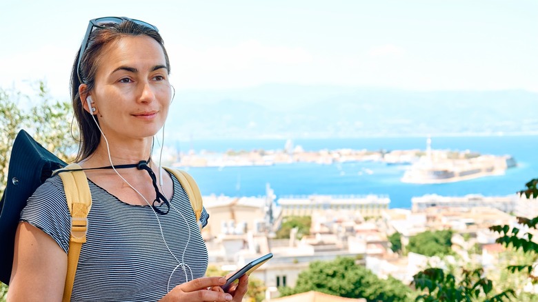 Woman listening to headphones in Europe