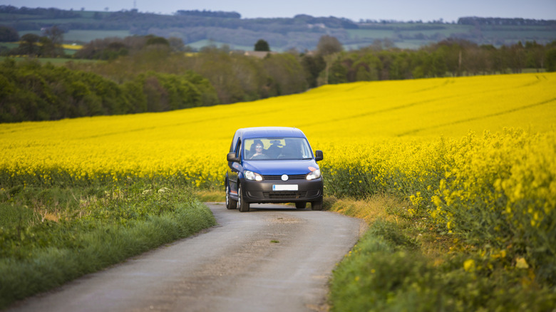 A small car driving through the English countryside