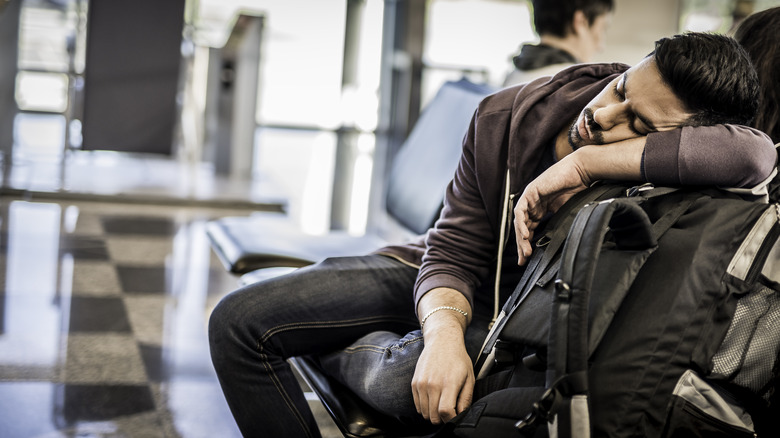 backpacker sleeps in airport 