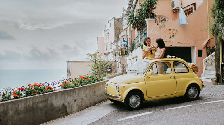 Two girls in a vintage car in Italy