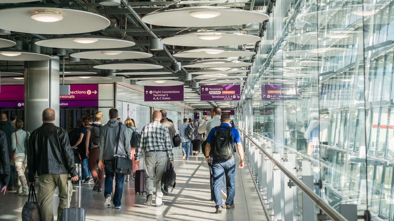 People walking through Heathrow airport