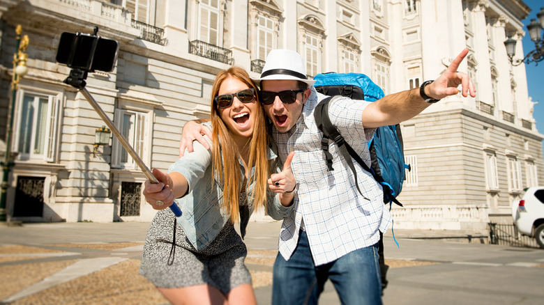 Tourists posing with selfie stick in Europe