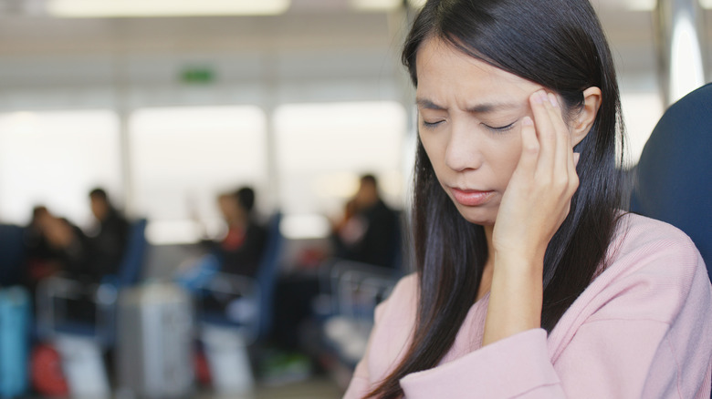 Woman with a headache on a ferry