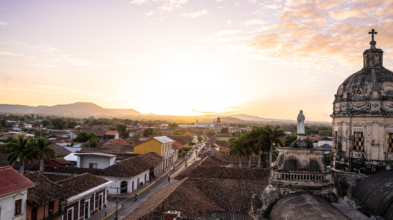 The city of Granada, Nicaragua, with sun on horizon