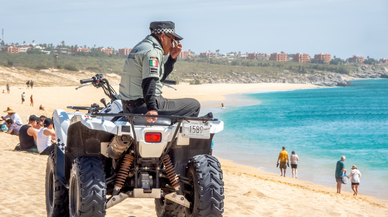 Police officer patrolling the beach at Los Cabos, Mexico