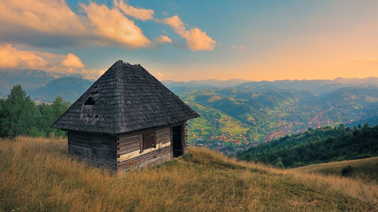 A hut on a hill at sunset overlooking Magura, Romania