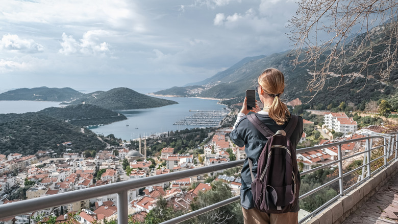 A woman taking pictures of a view