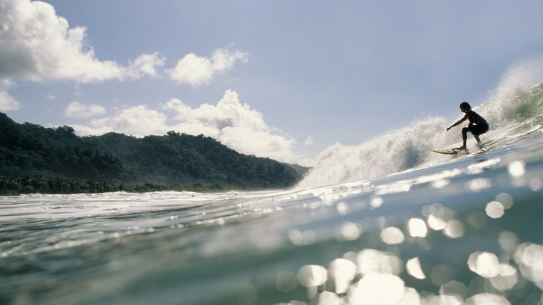 Surfer on sparkling wave in Costa Rica