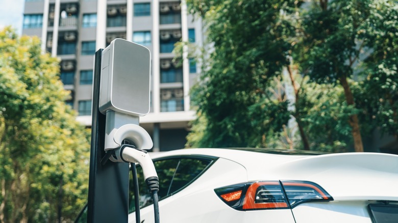 EV charger and car in front of hotel property.