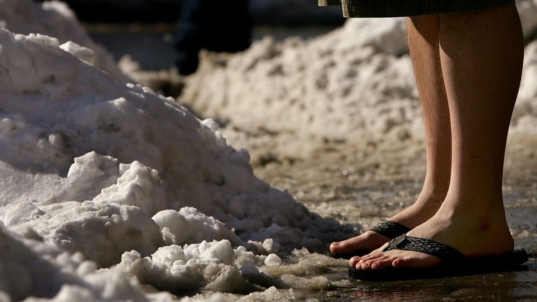 A person wearing flip flops in snow