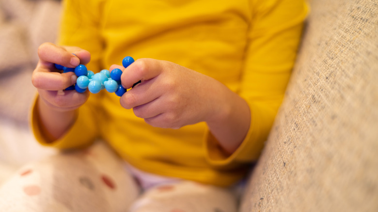 Little girl playing with fidget toy