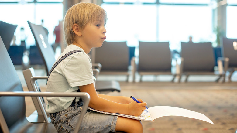 A child sitting in an airport