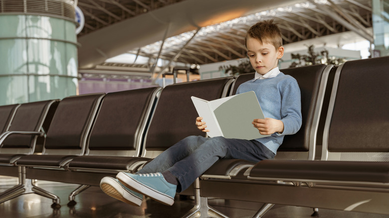 Family at airport watching tablet