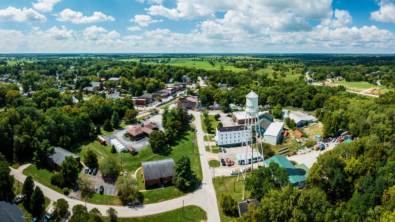 Aerial view of Midway, Kentucky's trees, houses, and water tower