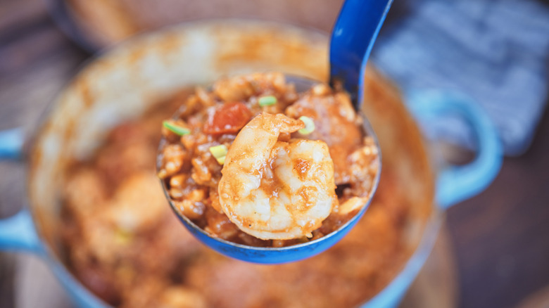 Blue pot and ladle of seafood stew