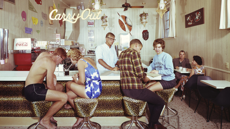 An old photo of people dining at the Motel Safari coffee shop