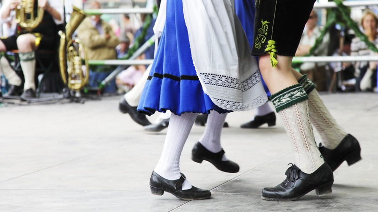 A man and woman's legs in Bavarian clothes while dancing