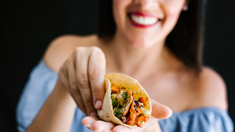 Woman holding a taco