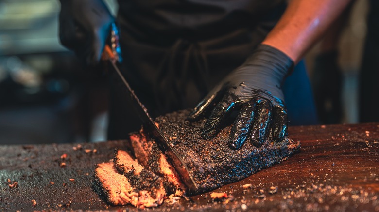 Slicing freshly cooked barbecue brisket