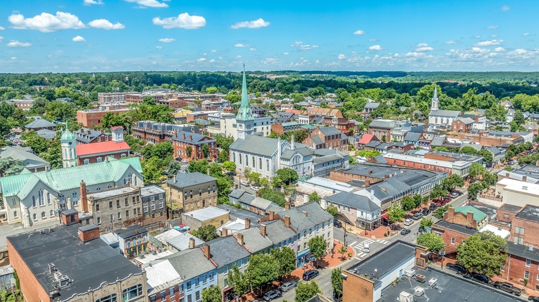 Aerial view Fredericksburg, Virginia during the day with historic buildings, trees, and businesses showing.